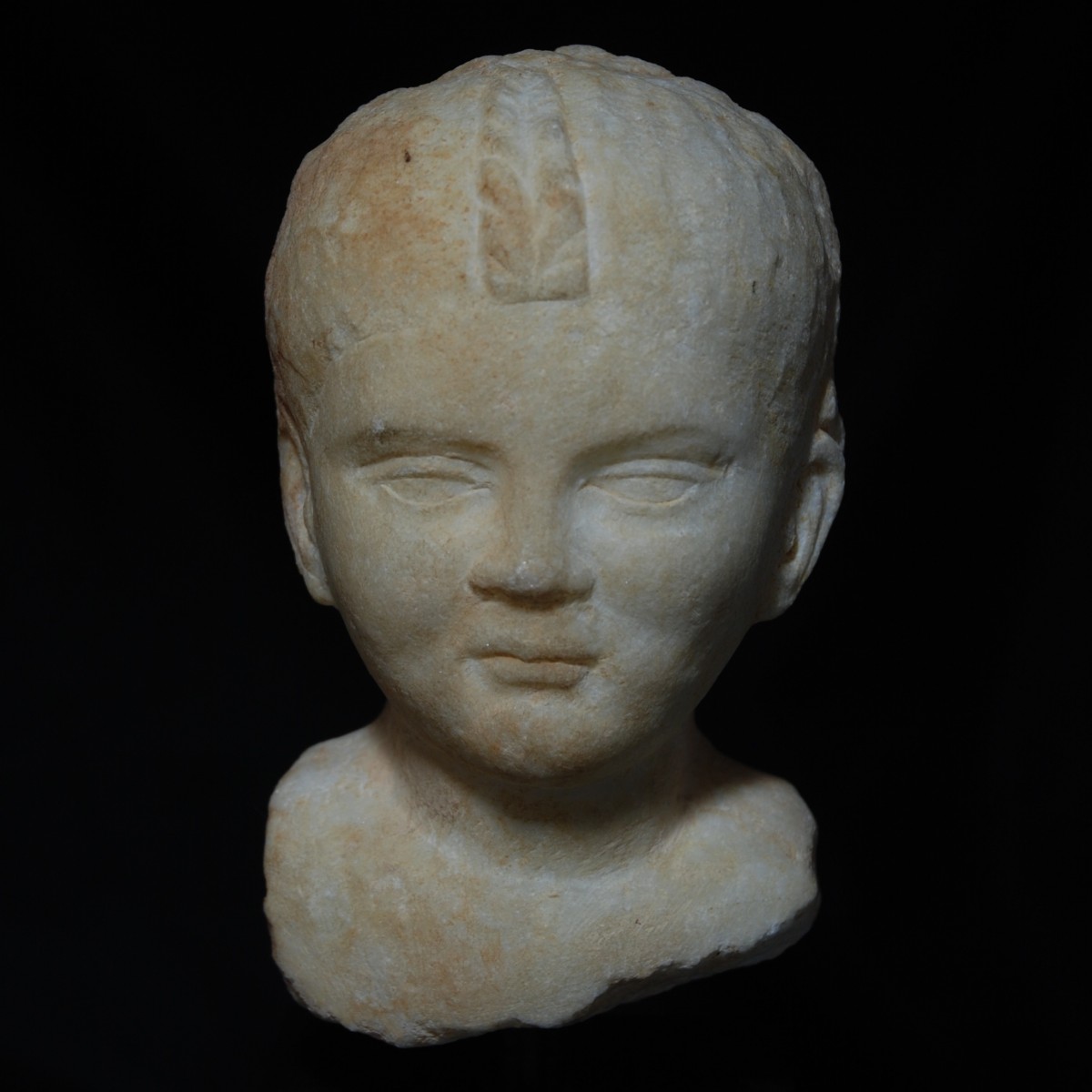 Roman marble head of girl with braided hair front