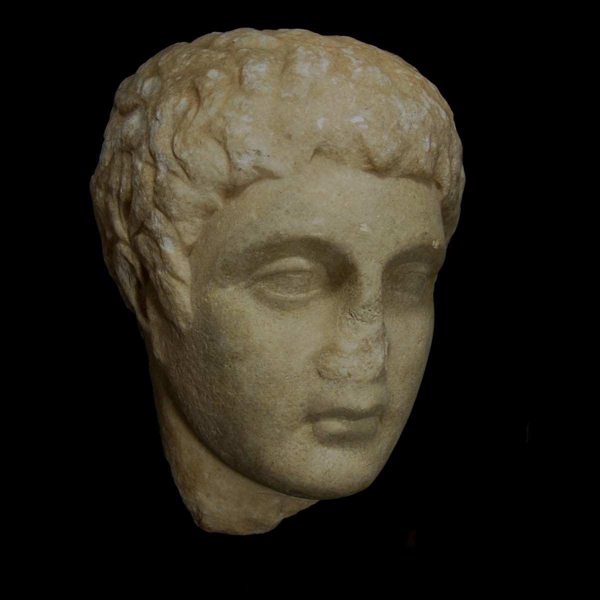 Greek marble relief head of a youth