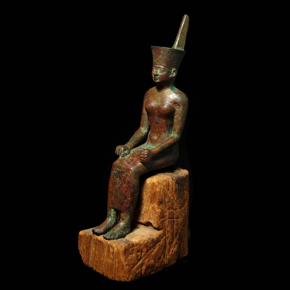 Bronze statuette of seated Neith half left