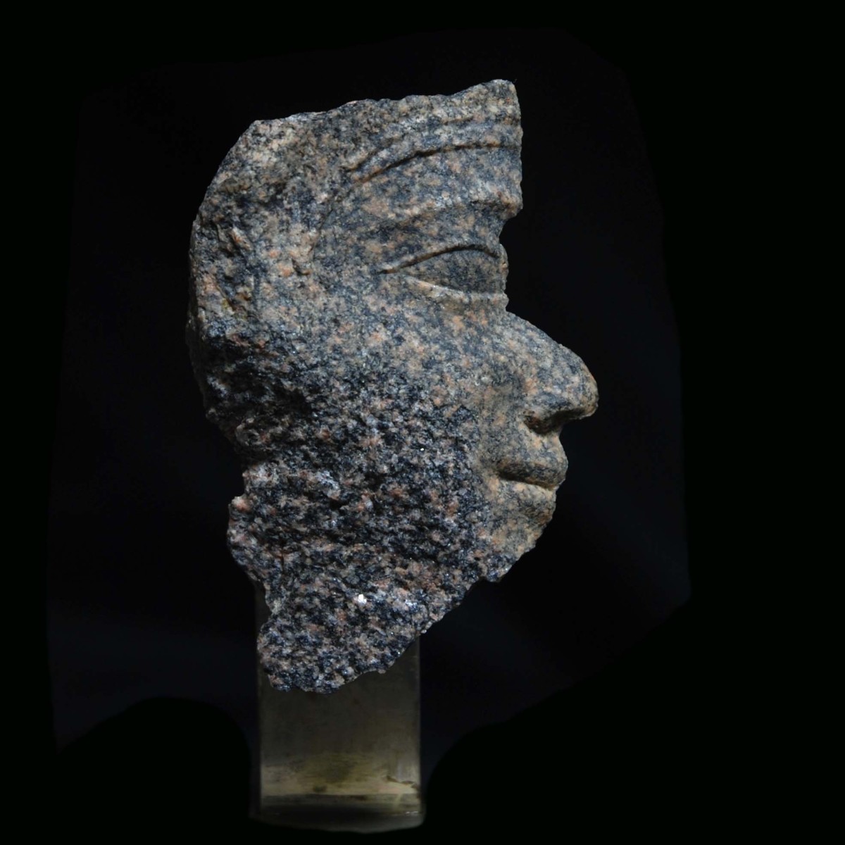 Egyptian granite relief fragment with the head of a royal