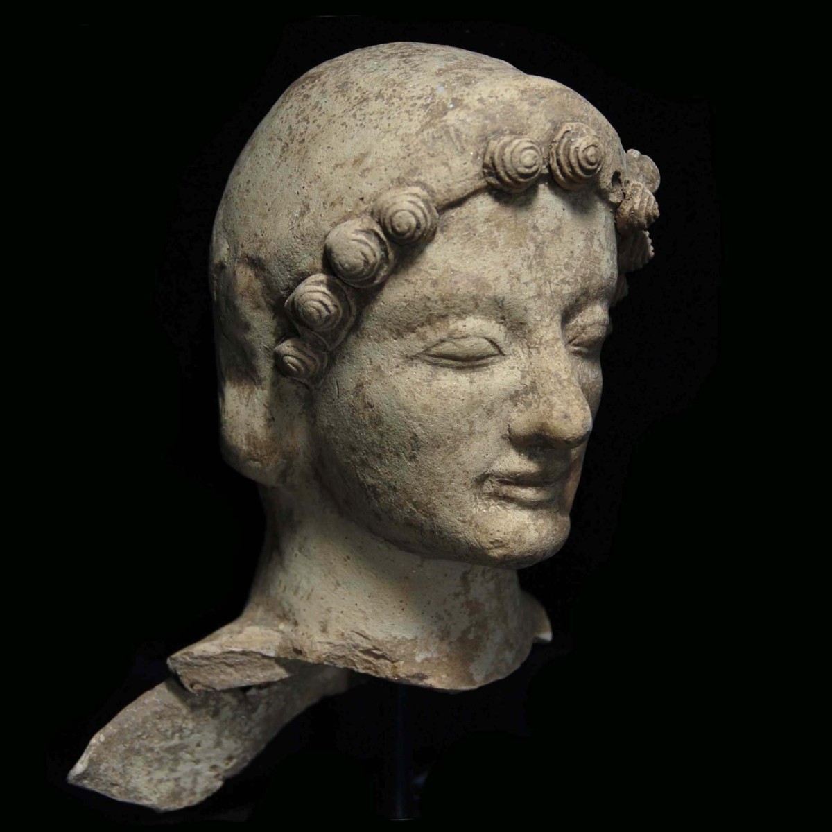 Greek archaic terracotta head of a godess half right