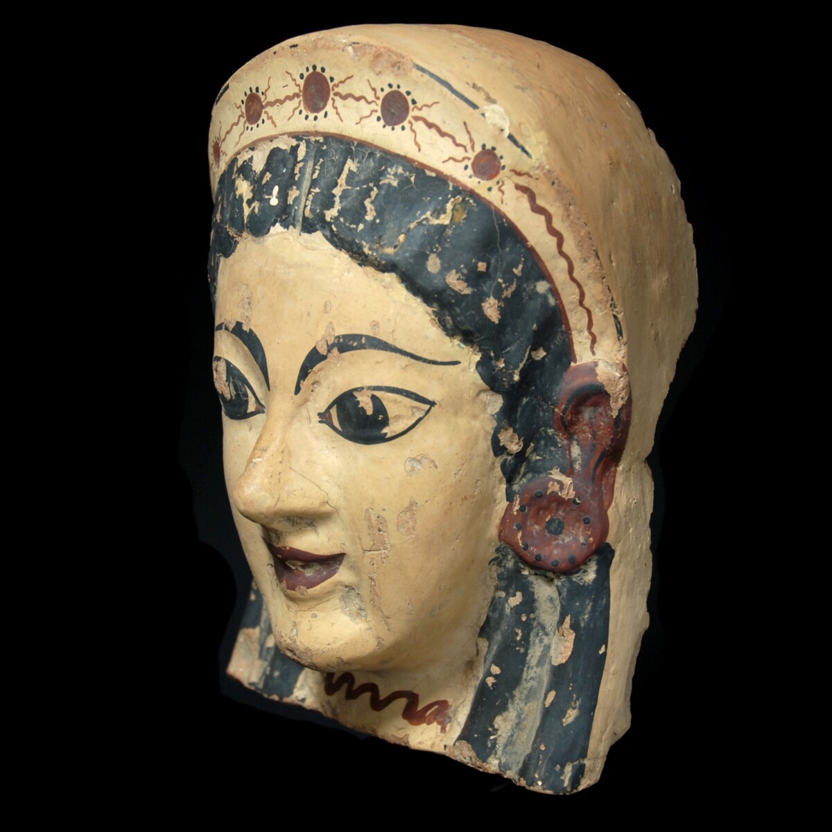 Archaic etruscan terracotta antefix with the head of a woman half left