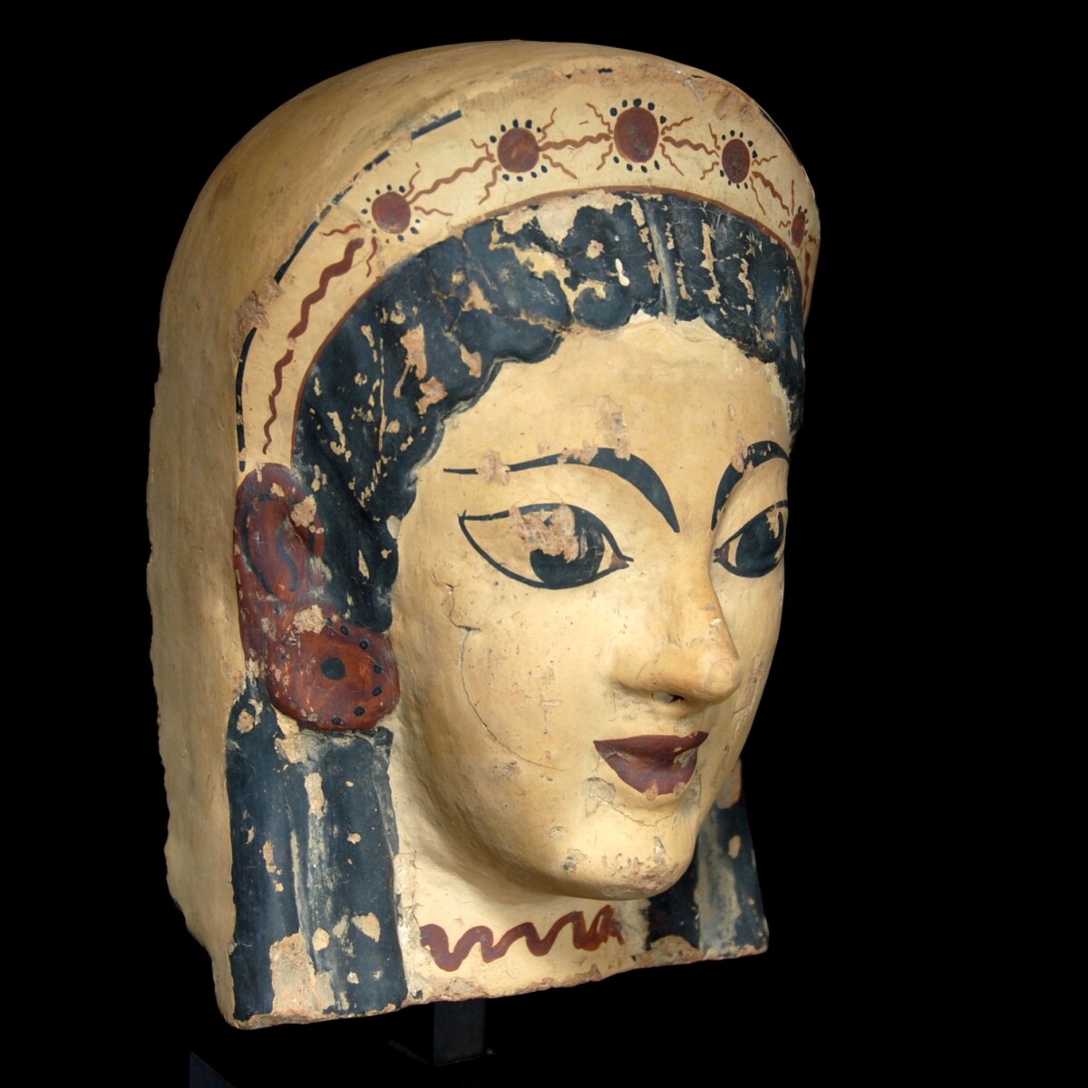 Archaic etruscan terracotta antefix with the head of a woman half right