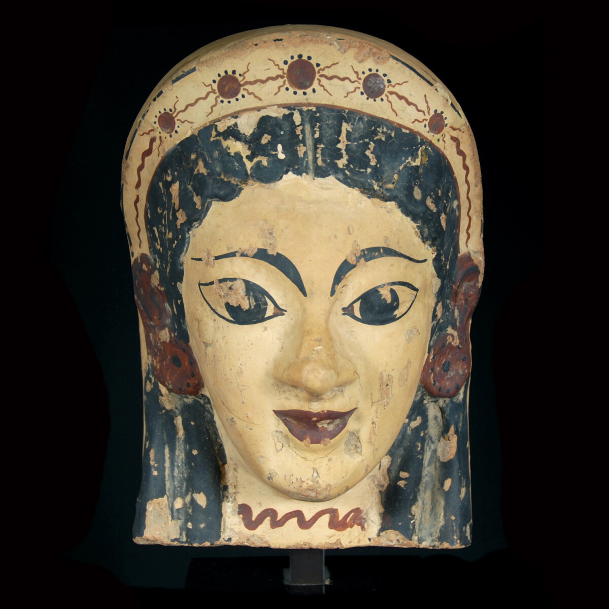 Archaic etruscan terracotta antefix with the head of a woman
