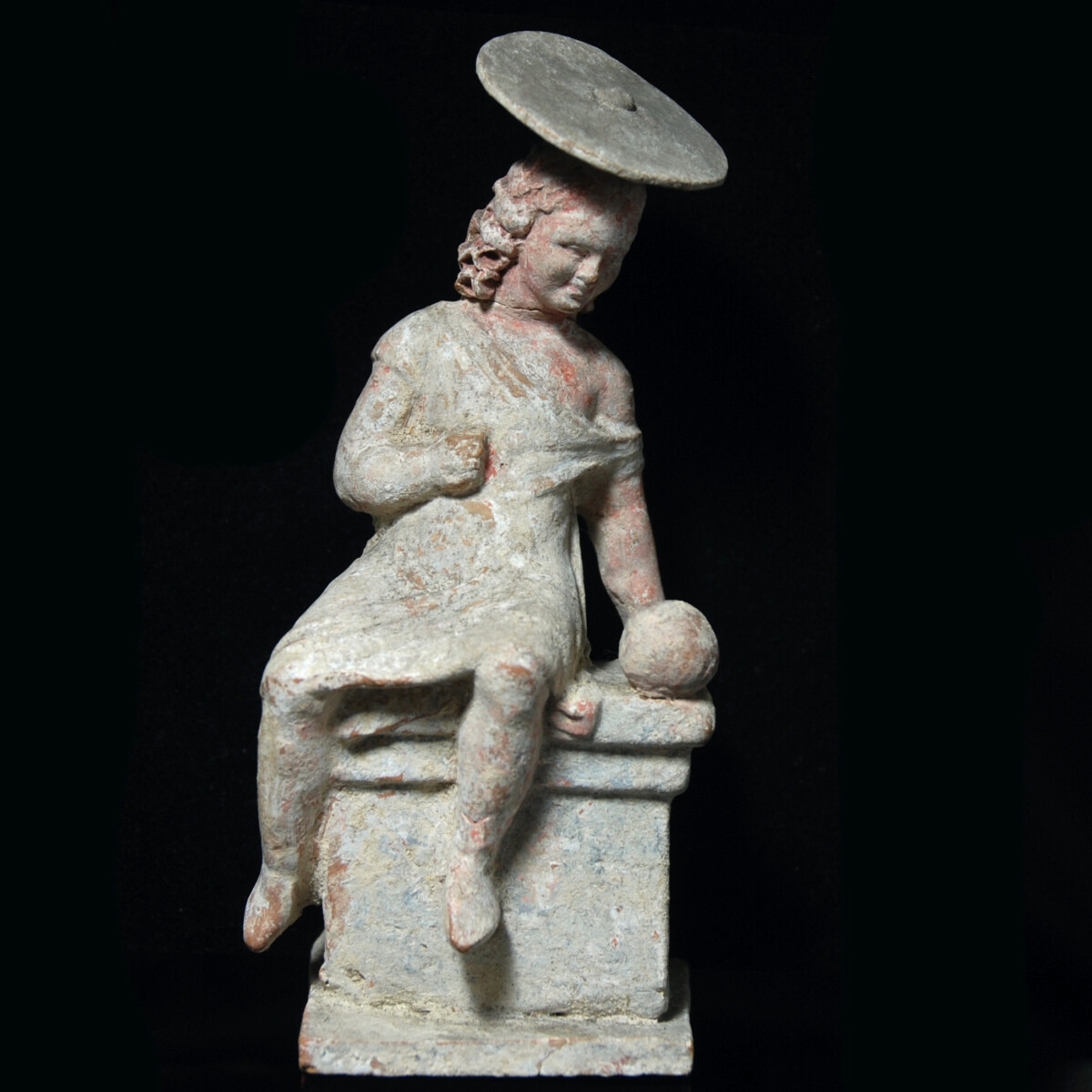 Hellenistic Tanagra statuette of a girl with sun hat and ball