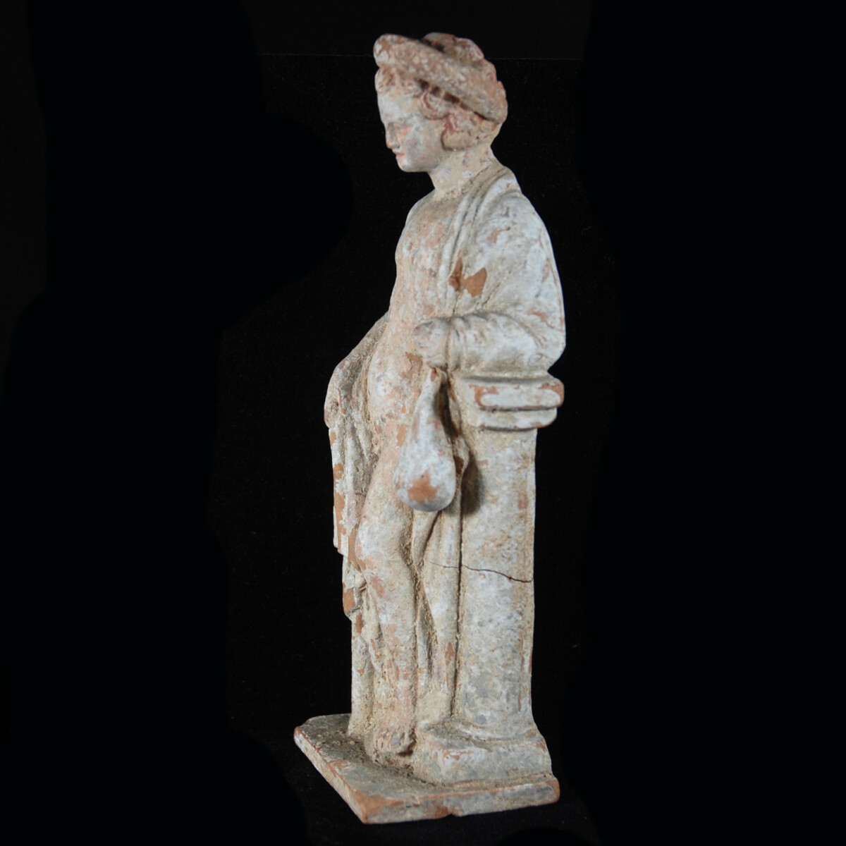 3 Tanagra statuette of a boy with money bag left