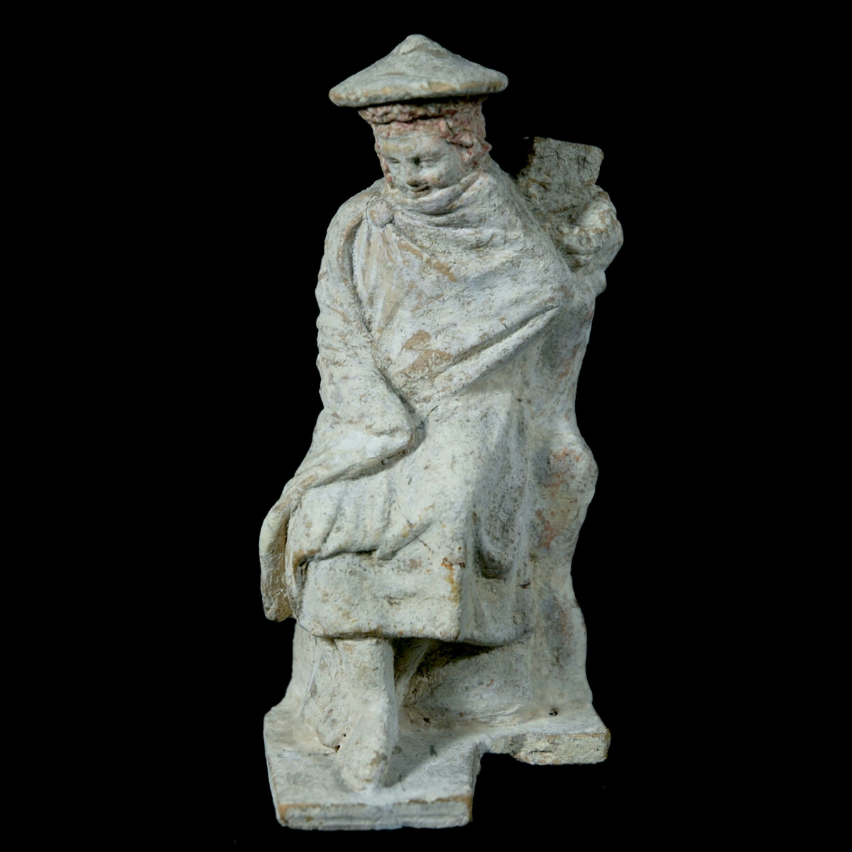 Tanagra statuette of a boy leaning on a stele