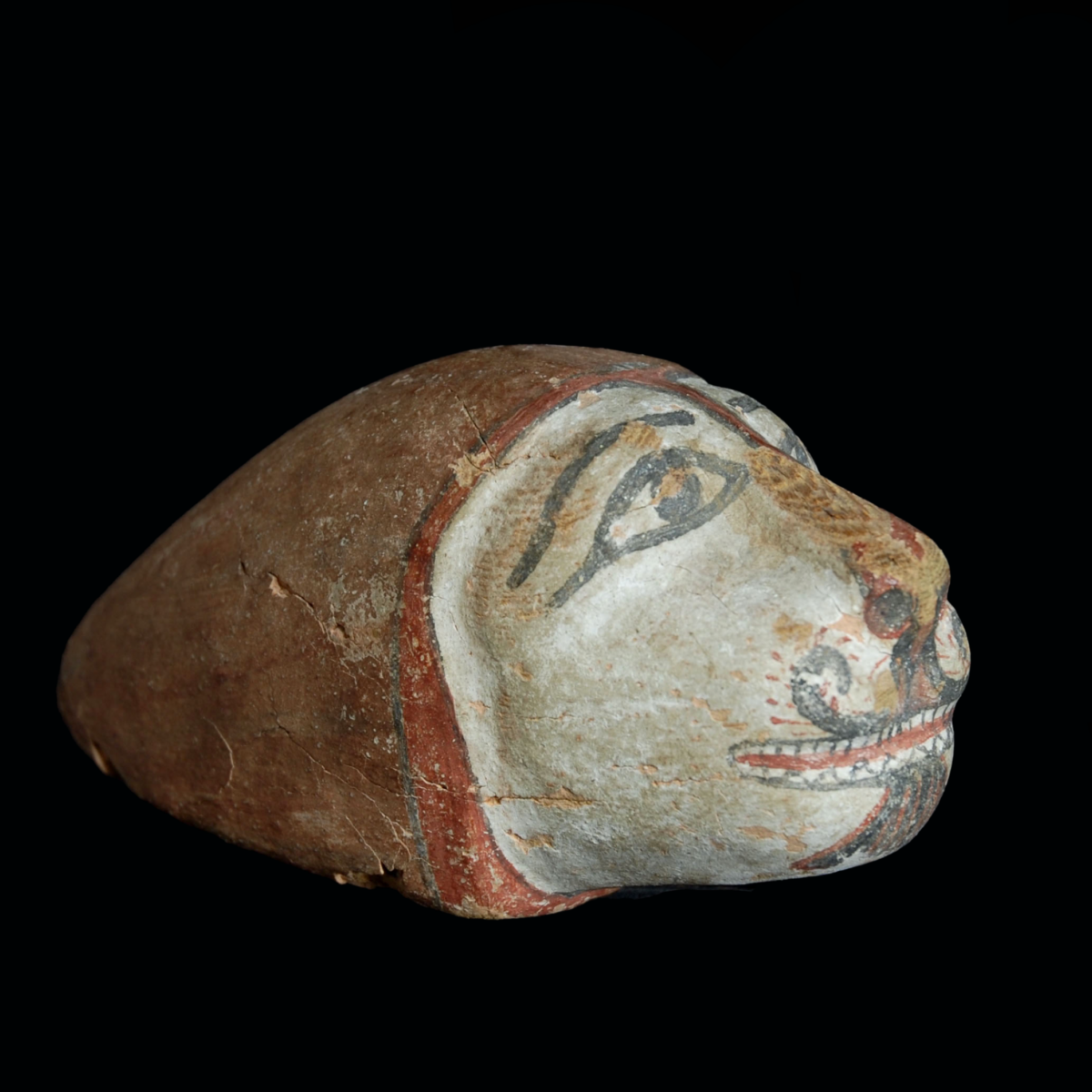 Egyptian wood head of a lion half right