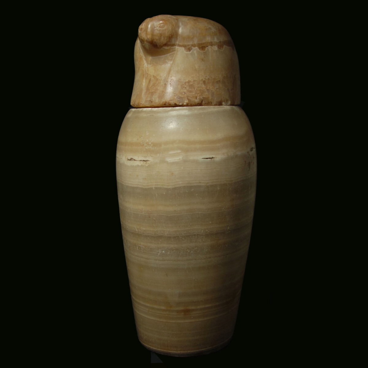 Egyptian canopic jar and lid of Qebehsenuef left