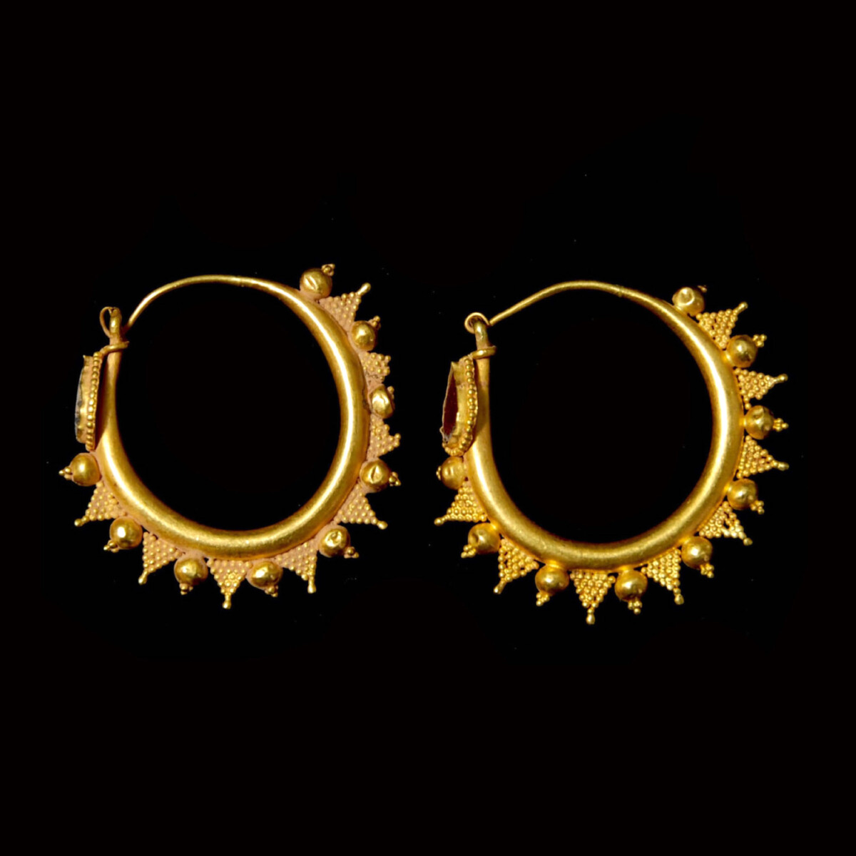 Greek gold hoop earrings with garnet side